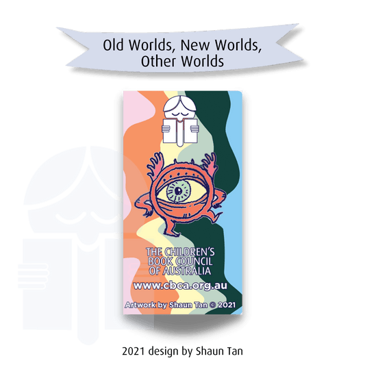 An image of a character brooch in the shape of a round eyeball with legs and arms. Text on a graphic flag reads "Old world, new worlds, other worlds." Text at the base of the image reads 2021 design by Shaun Tan,"