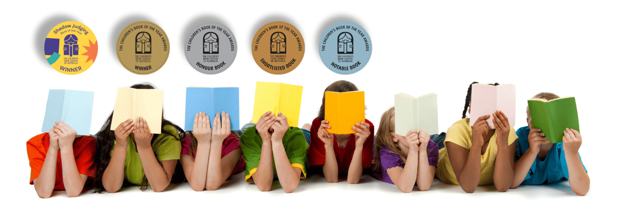 a line of children are lying on their stomachs holding themselves up by resting on their elbows. Their faces are all hidden by the cover of an open book they each hold in their hands. Above their heads is a circular award medal.
